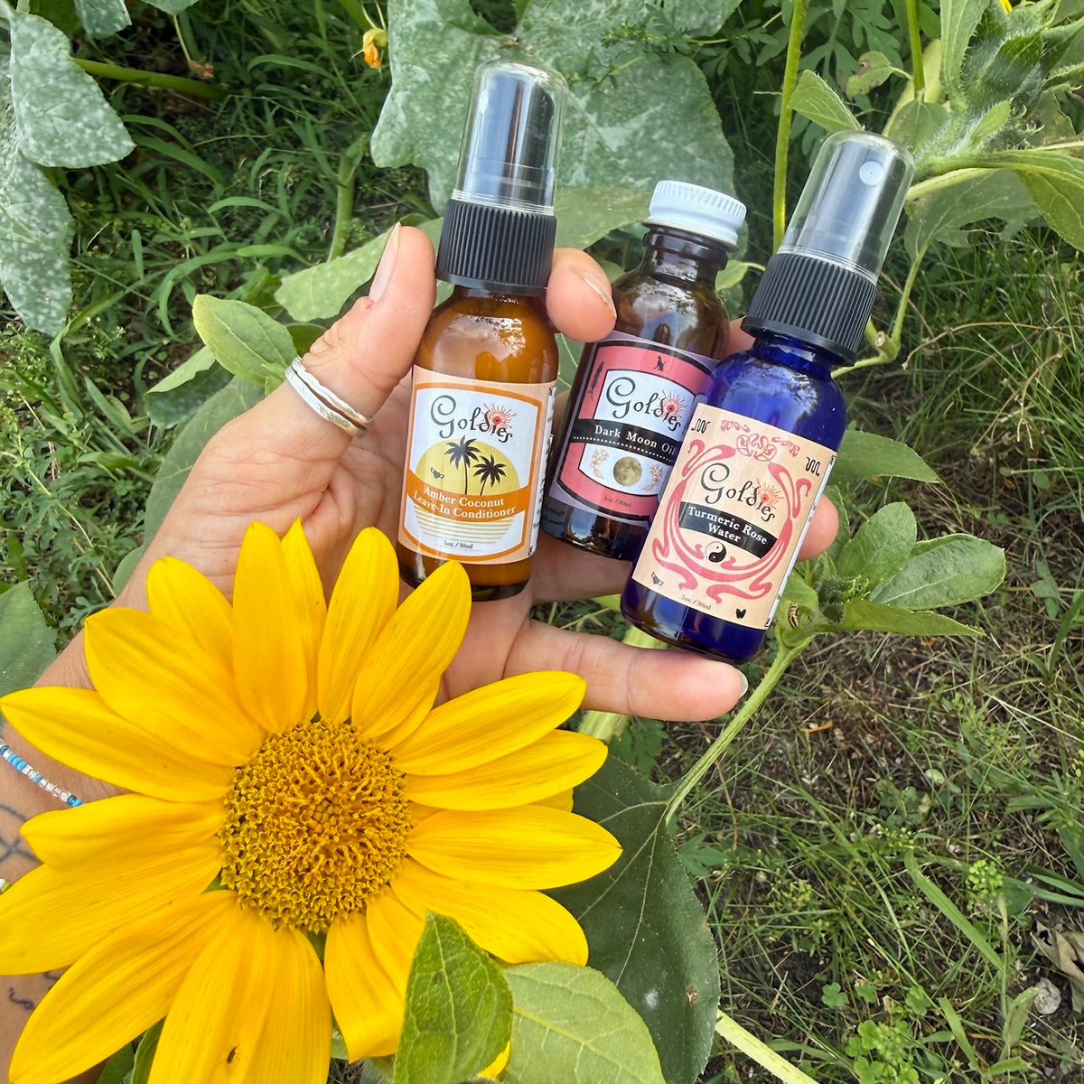 Goldies Mini Set with Dark Moon Oil, Turmeric Rose Water and Amber Coconut Leave-In in a sunset print canvas pouch